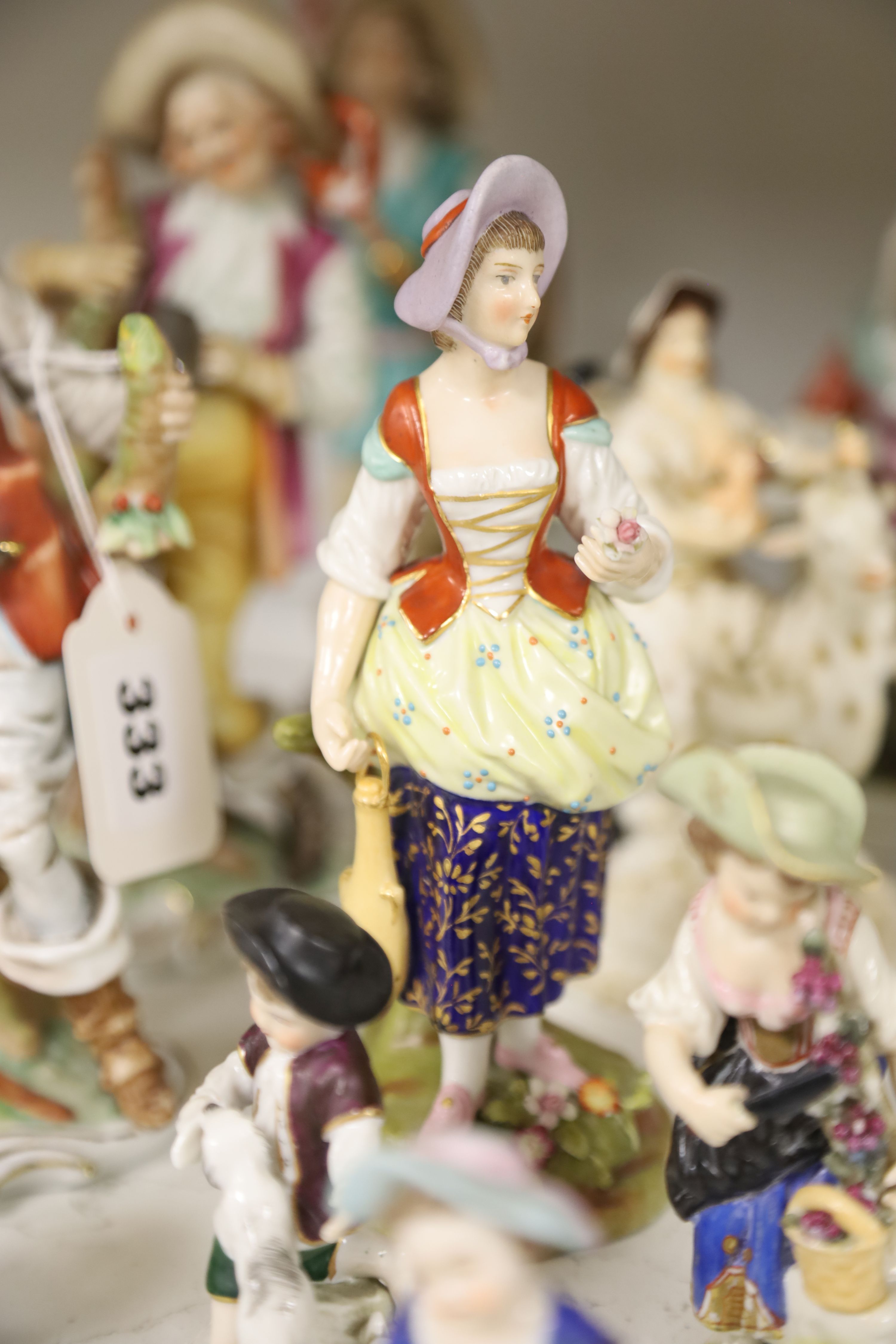 A Derby tailors wife group and twelve Continental or Staffs porcelain figures, tallest 20cm